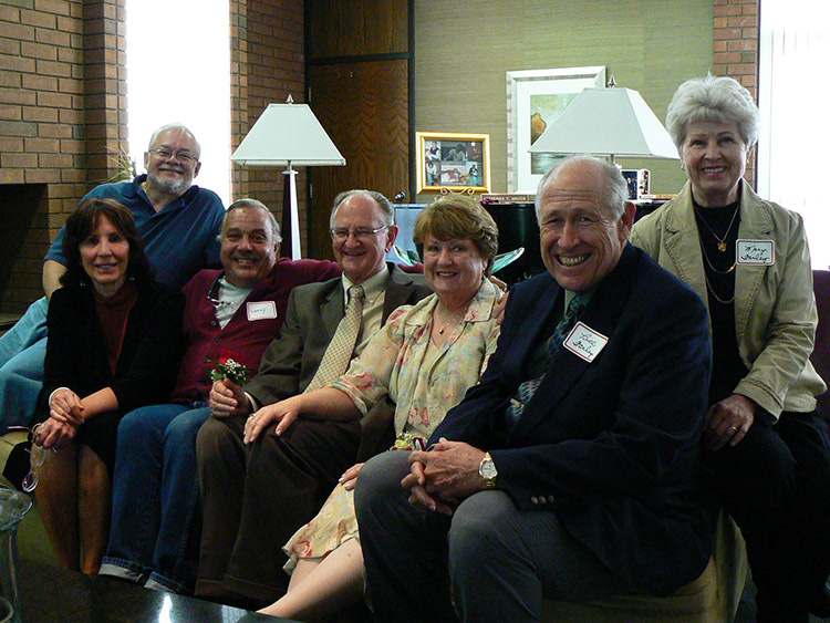 Dr. Fred Janzen and his wife, surrounded by social work faculty