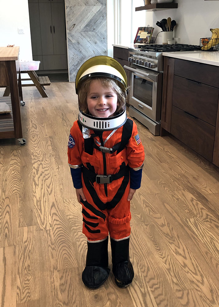 a little kid in an astronaut costume