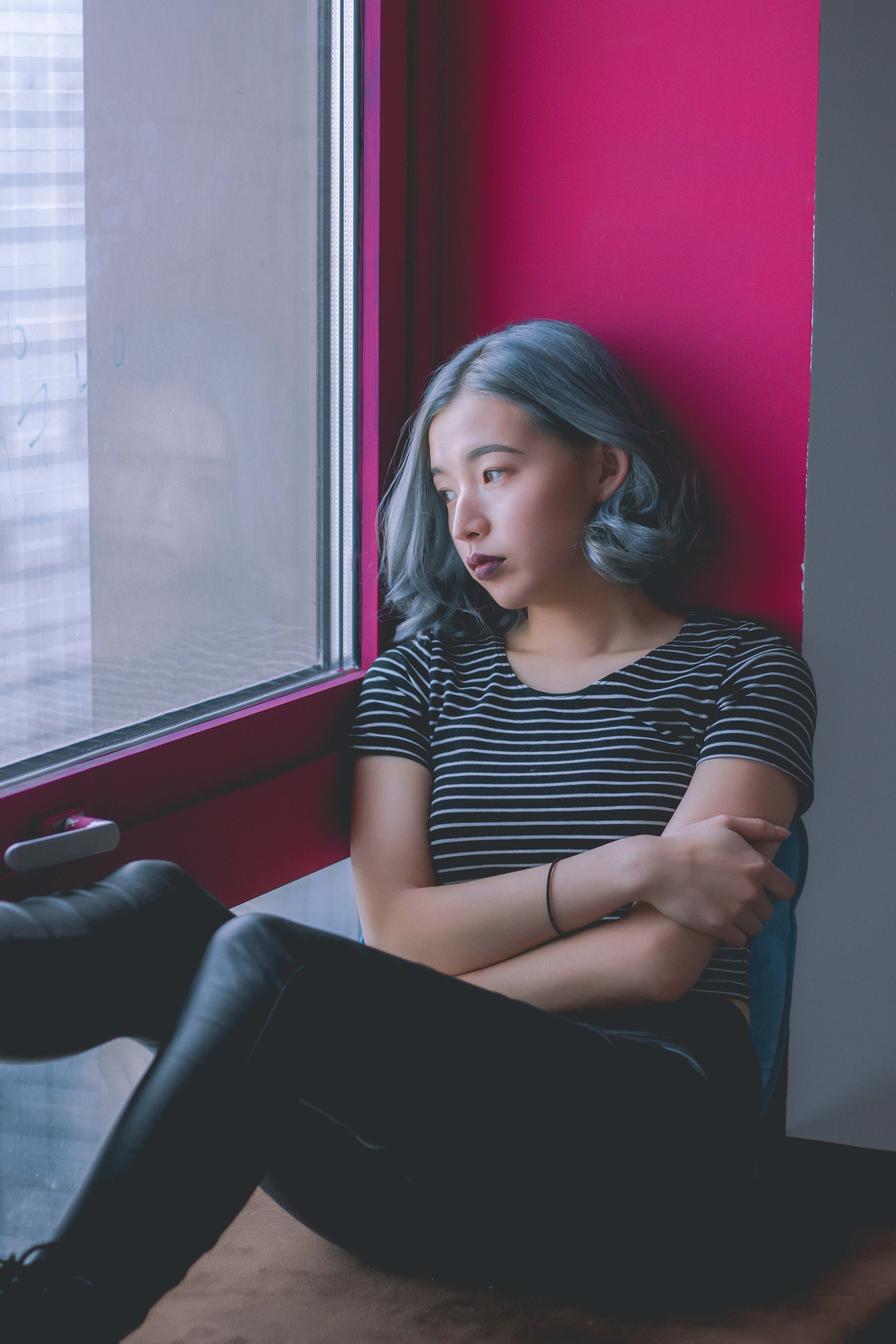 a woman looks out a window