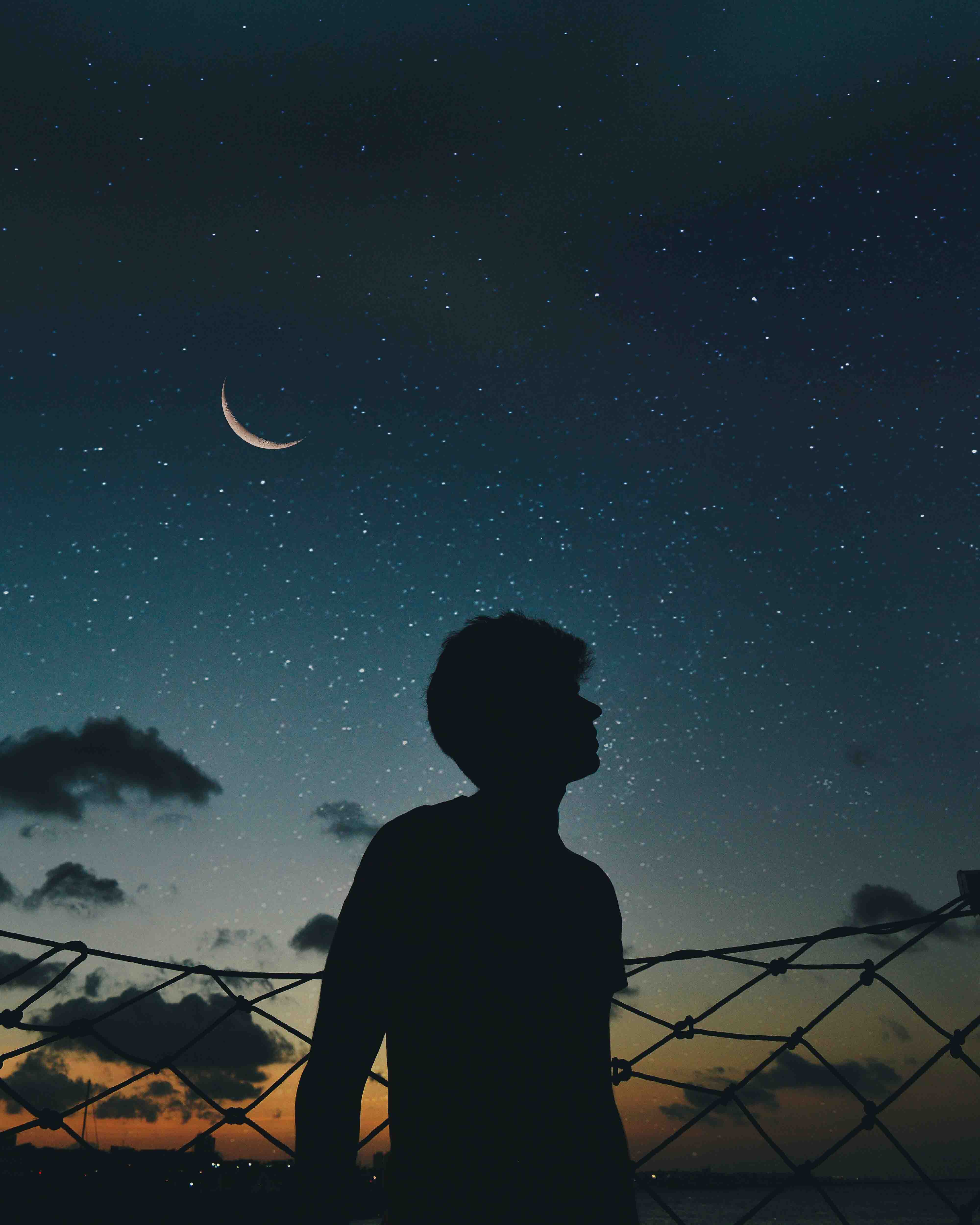 a man sillouetted against a night sky