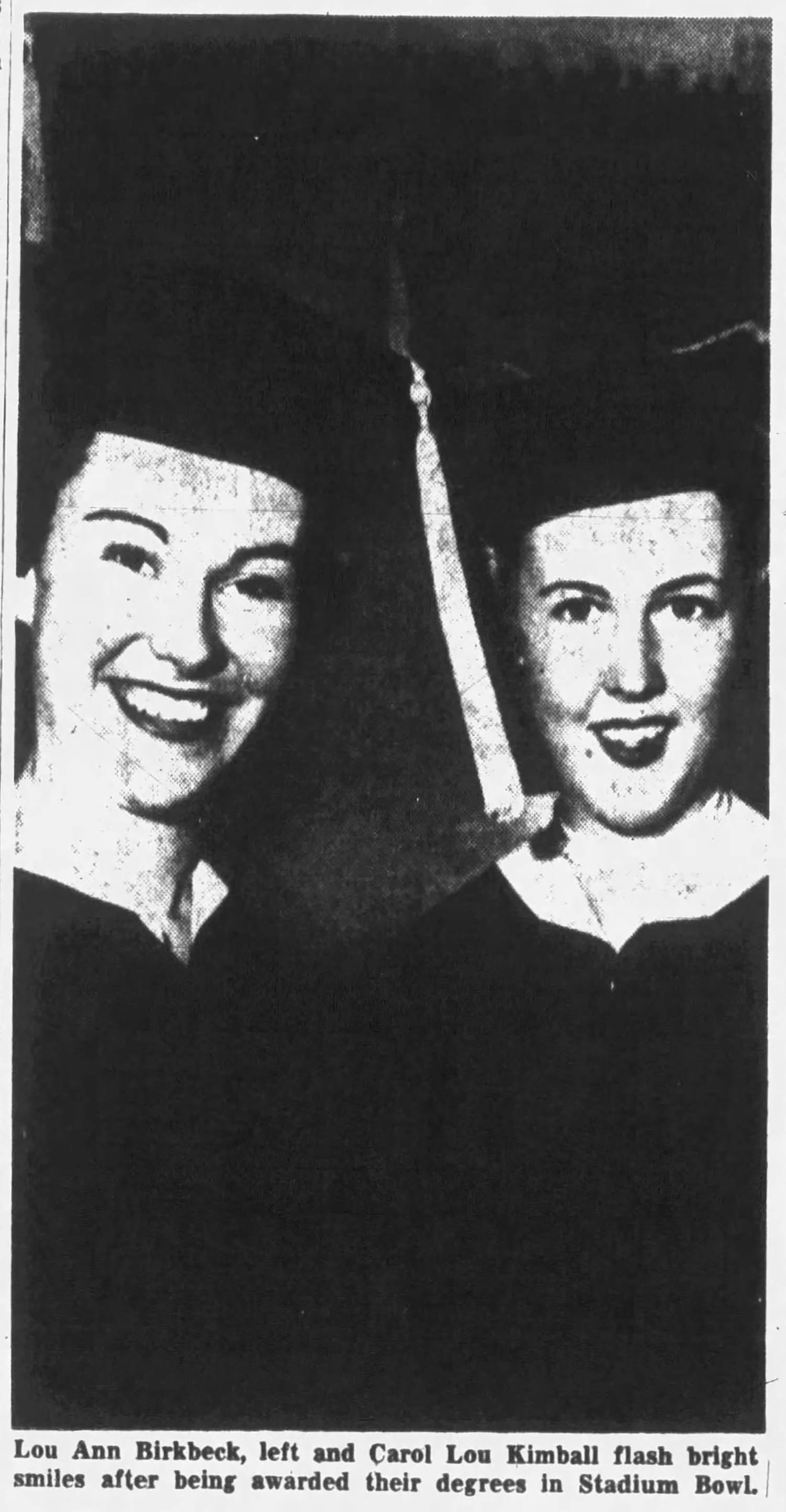 Photo of Lou Ann Birkbeck and Carol Lou Kimball wearing graduation regalia at the University of Utah Commencement Ceremony