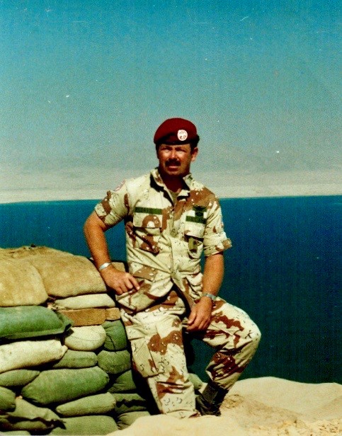 Major Davis leaning on a stack of sandbags, Sinai, Egypt.