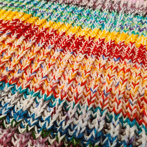 a close up of colorful, textured knitting.